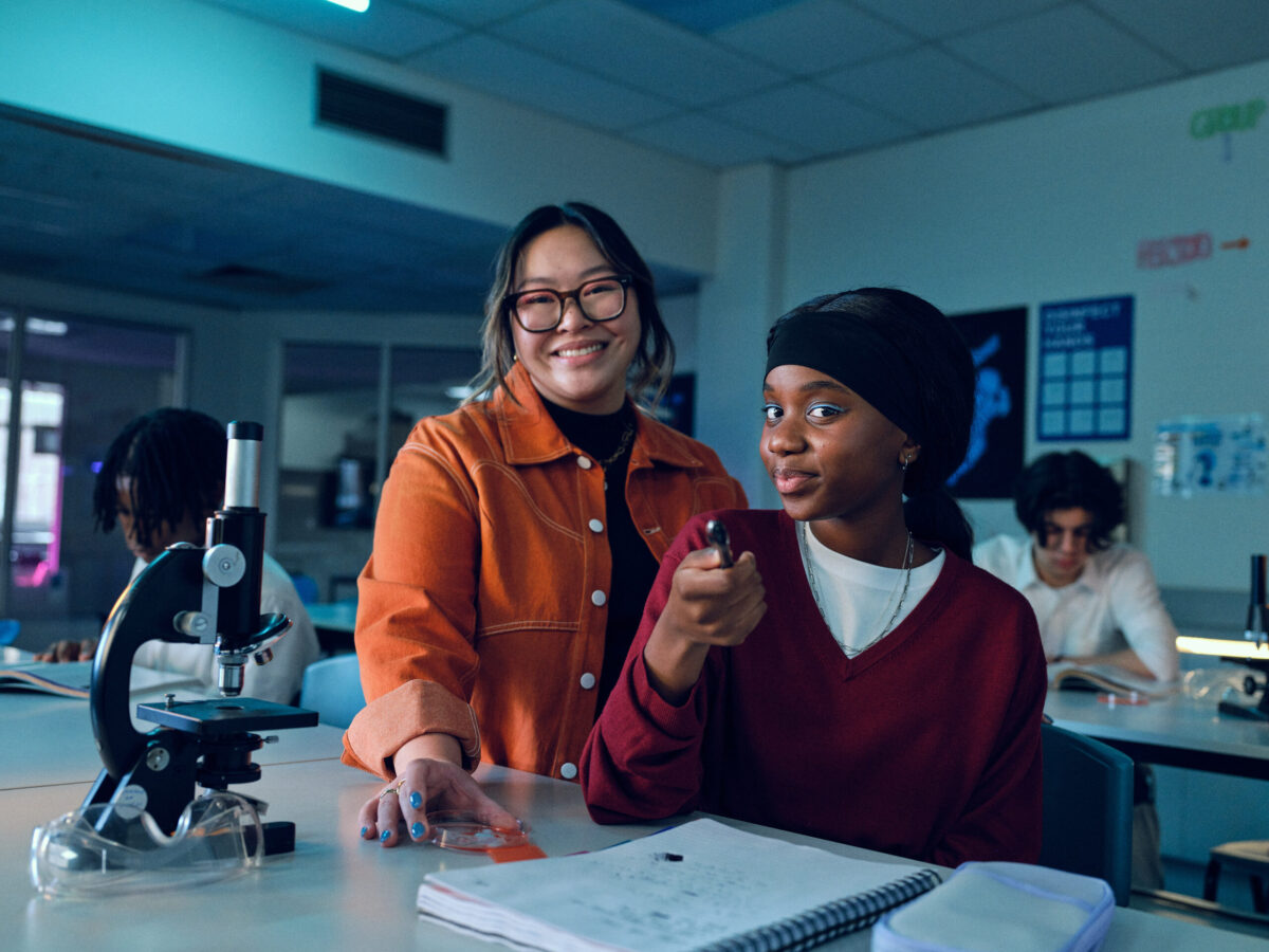 In image of a teacher and a student in a science lab room